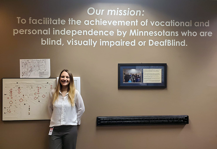 Natasha Jerde, who has two degrees in rehabilitation from UW-Stout, stands by the Minnesota State Services for the Blind mission statement in St. Paul.