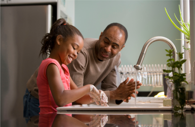 Father and daughter washing hands